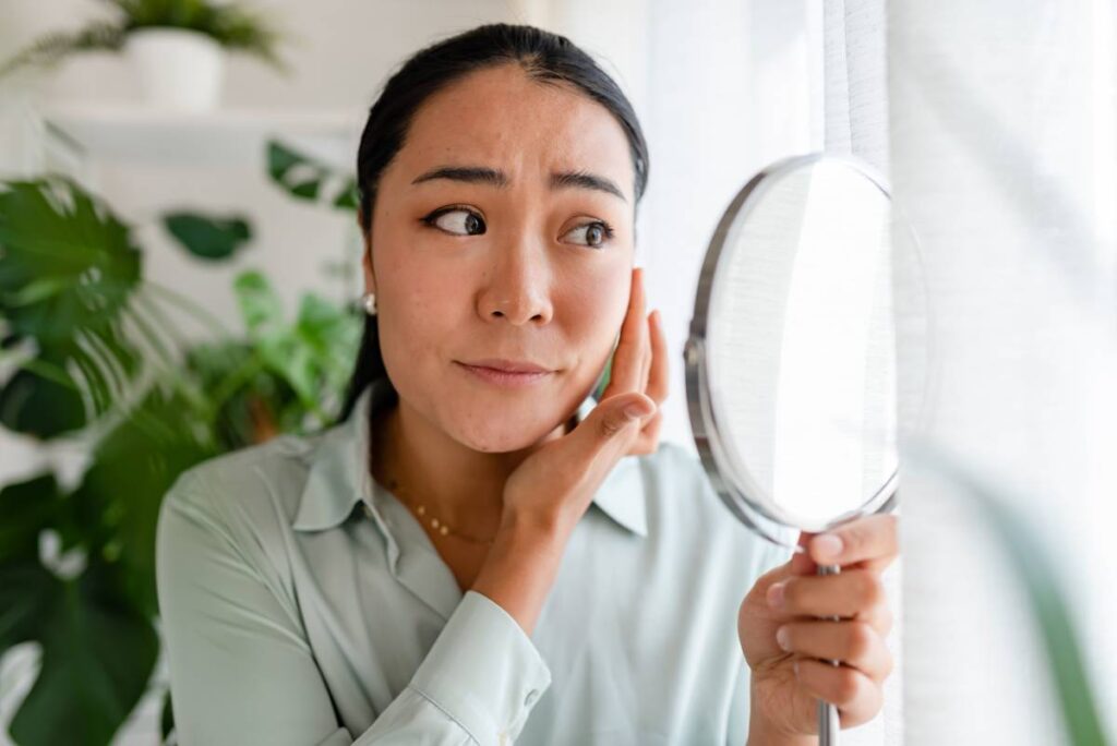 woman checking to see if under eye bags have developed